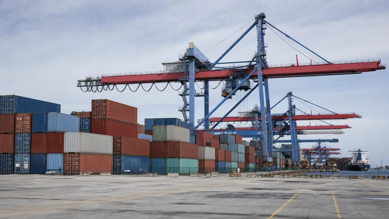 Shipping containers and cranes at a modern logistics port