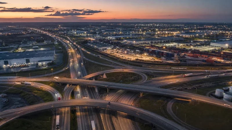 Highway interchange and logistics corridor at dusk
