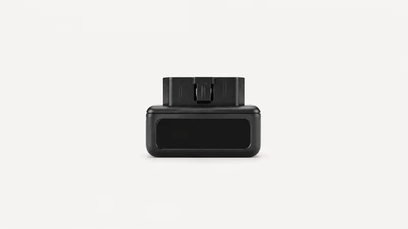Isolated a plug-in vehicle telematics dongle with a blank status window centred on a seamless pale off-white studio background, generous empty margin on every side for overlaid branding