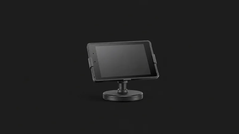 Isolated a tablet point-of-sale stand with a swivel base centred on a seamless deep charcoal near-black studio background, generous empty margin on every side for overlaid branding