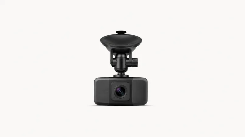 Isolated a windscreen-mounted dash camera with a suction cup and small lens centred on a seamless pale off-white studio background, generous empty margin on every side for overlaid branding