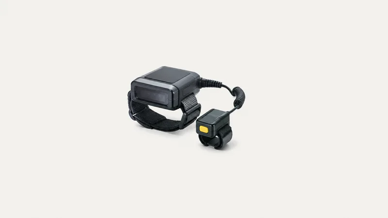Isolated a wrist-mounted wearable scanner with a finger ring reader centred on a seamless pale off-white studio background, generous empty margin on every side for overlaid branding