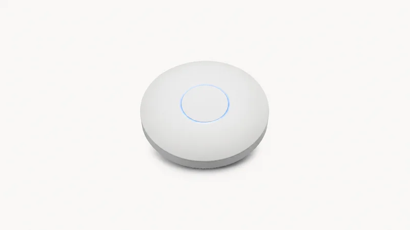 Isolated a wireless access point puck with a status ring centred on a seamless pale off-white studio background, generous empty margin on every side for overlaid branding