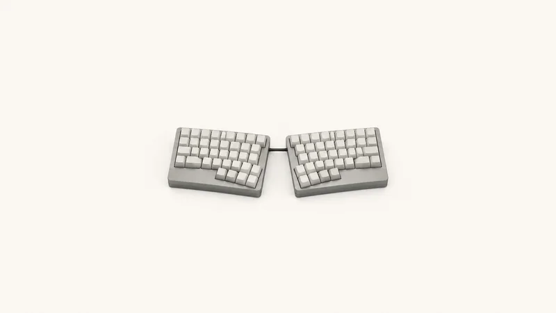 Isolated a split ergonomic keyboard with blank keycaps centred on a seamless pale off-white studio background, generous empty margin on every side for overlaid branding