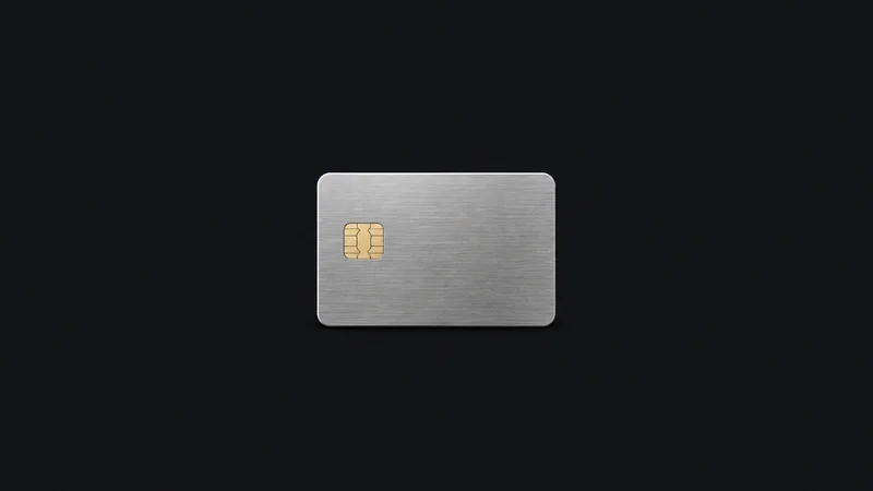 Isolated a brushed-metal chip card with an exposed gold contact plate centred on a seamless deep charcoal near-black studio background, generous empty margin on every side for overlaid branding