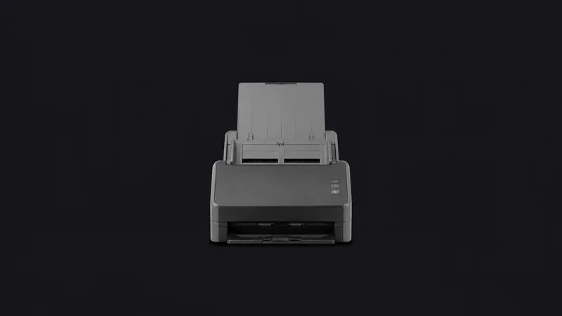 Isolated a sheet-fed desktop document scanner with a raised paper tray centred on a seamless deep charcoal near-black studio background, generous empty margin on every side for overlaid branding