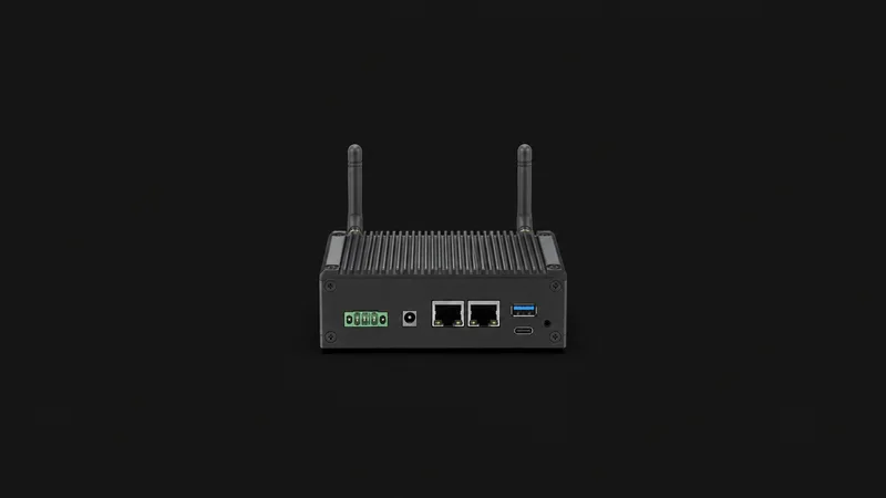 Isolated an industrial iot gateway with two stub antennas and unlit status leds centred on a seamless deep charcoal near-black studio background, generous empty margin on every side for overlaid branding
