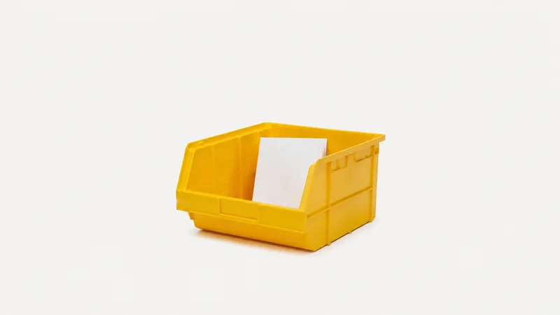 Isolated a yellow plastic pick tote with a folded blank pick list inside centred on a seamless pale off-white studio background, generous empty margin on every side for overlaid branding