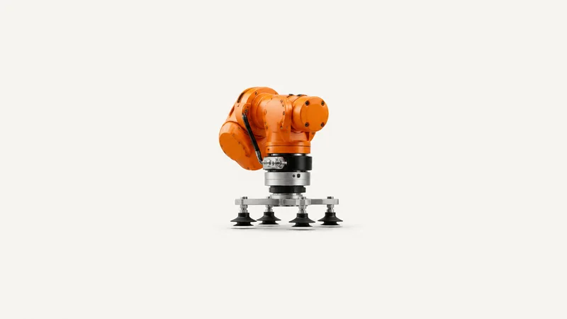 Isolated an orange articulated robot arm wrist joint fitted with a vacuum suction end effector centred on a seamless pale off-white studio background, generous empty margin on every side for overlaid branding