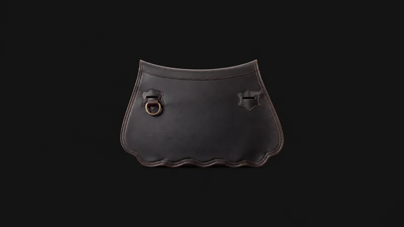 Isolated a hand-stitched leather saddle flap with a scalloped edge centred on a seamless deep charcoal near-black studio background, generous empty margin on every side for overlaid branding