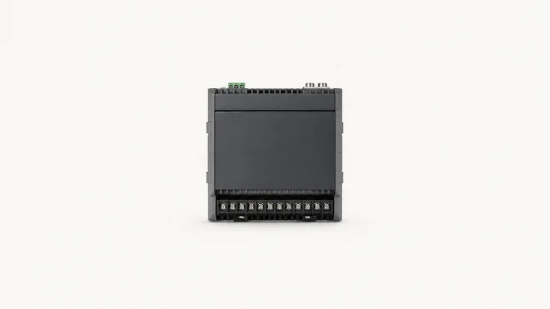Isolated a din-rail edge controller module with a row of unlabelled terminals centred on a seamless pale off-white studio background, generous empty margin on every side for overlaid branding