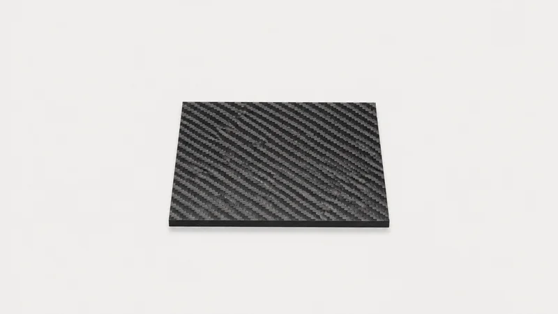 Isolated a carbon-fibre laminate panel with a visible twill weave centred on a seamless pale off-white studio background, generous empty margin on every side for overlaid branding