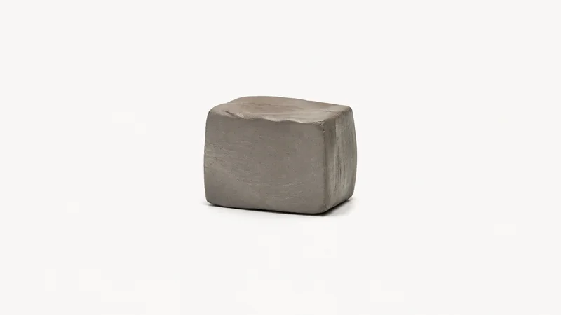 Isolated a wire-cut block of grey stoneware clay centred on a seamless pale off-white studio background, generous empty margin on every side for overlaid branding