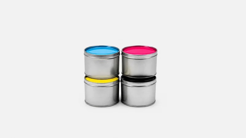 Isolated a set of CMYK process ink tins centred on a seamless pale off-white studio background, generous empty margin on every side for overlaid branding