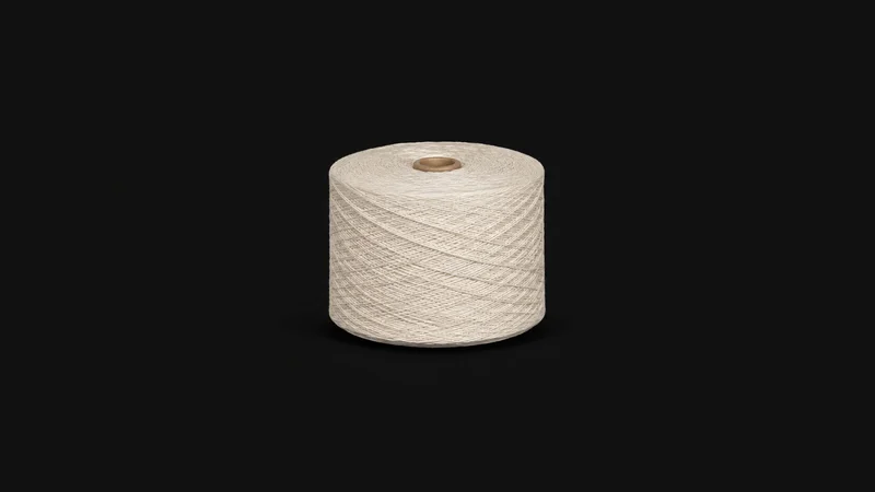 Isolated a wound bobbin of undyed cotton yarn centred on a seamless deep charcoal near-black studio background, generous empty margin on every side for overlaid branding