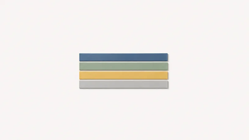 Isolated a set of magnetic whiteboard strips in four colours centred on a seamless pale off-white studio background, generous empty margin on every side for overlaid branding