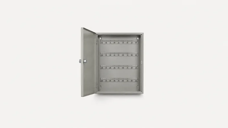 Isolated a wall-mounted steel key cabinet with numbered hooks centred on a seamless pale off-white studio background, generous empty margin on every side for overlaid branding