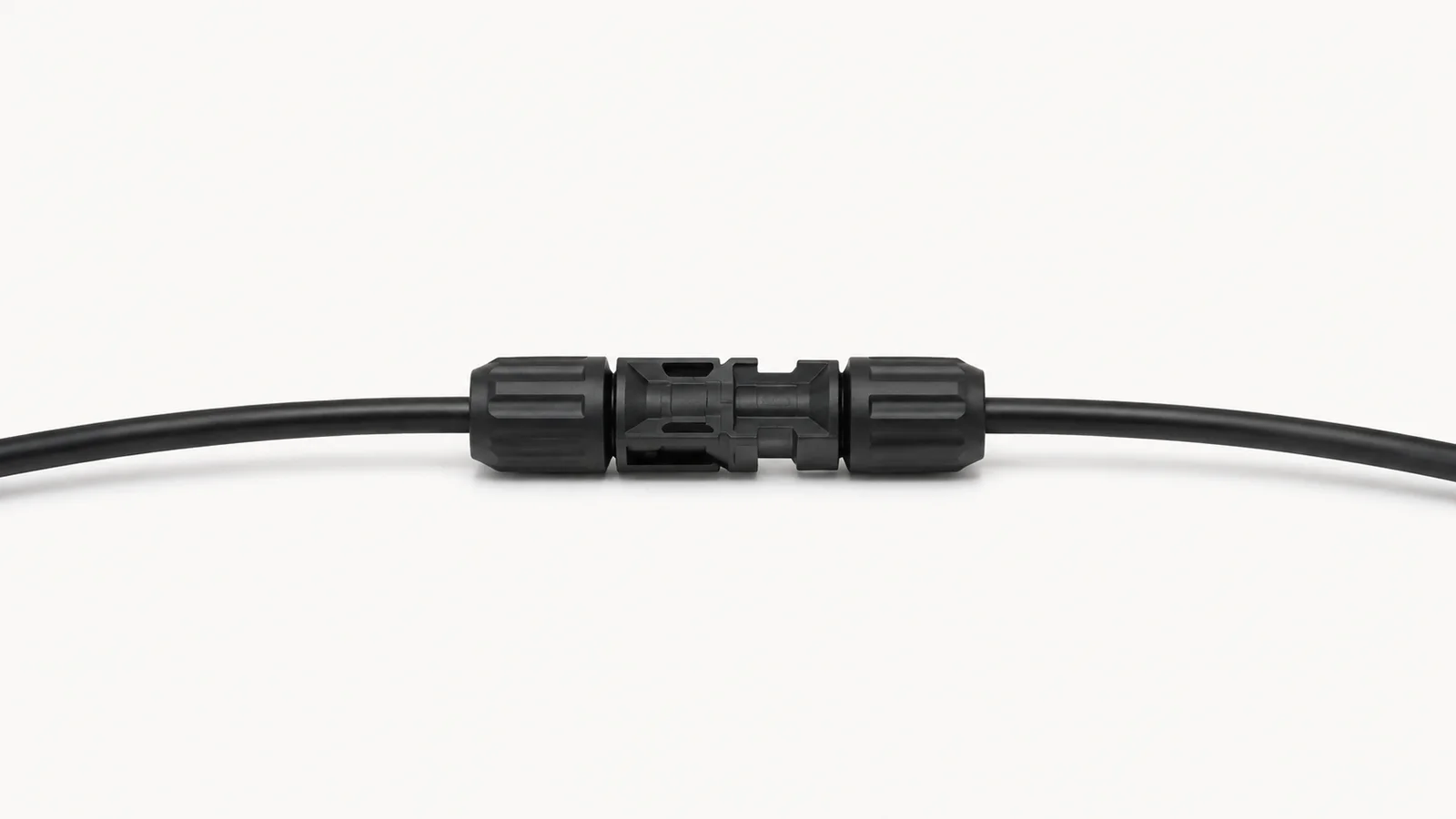 Isolated a pair of mated MC4 connectors on a length of cable centred on a seamless pale off-white studio background, generous empty margin on every side for overlaid branding