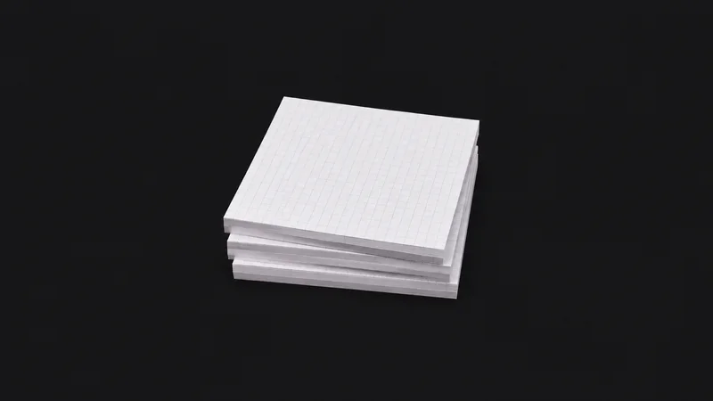 Isolated a stack of blank graph-paper pads centred on a seamless deep charcoal near-black studio background, generous empty margin on every side for overlaid branding