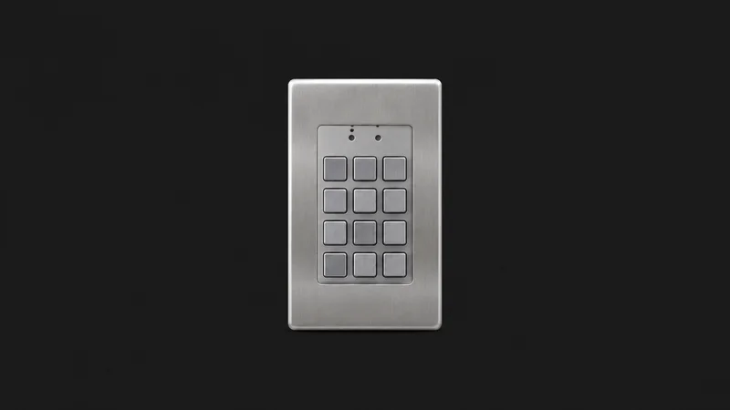 Isolated a keyless entry keypad plate in brushed metal with unmarked buttons centred on a seamless deep charcoal near-black studio background, generous empty margin on every side for overlaid branding
