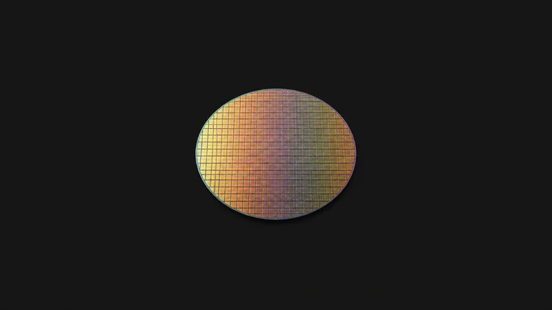 Isolated a bare eight-inch silicon wafer with a visible die grid centred on a seamless deep charcoal near-black studio background, generous empty margin on every side for overlaid branding