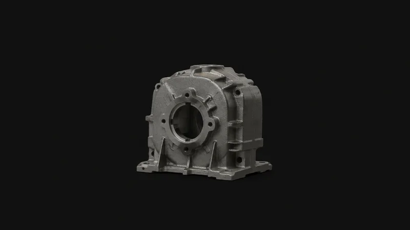 Isolated a cast grey-iron gear housing fresh from the mould centred on a seamless deep charcoal near-black studio background, generous empty margin on every side for overlaid branding