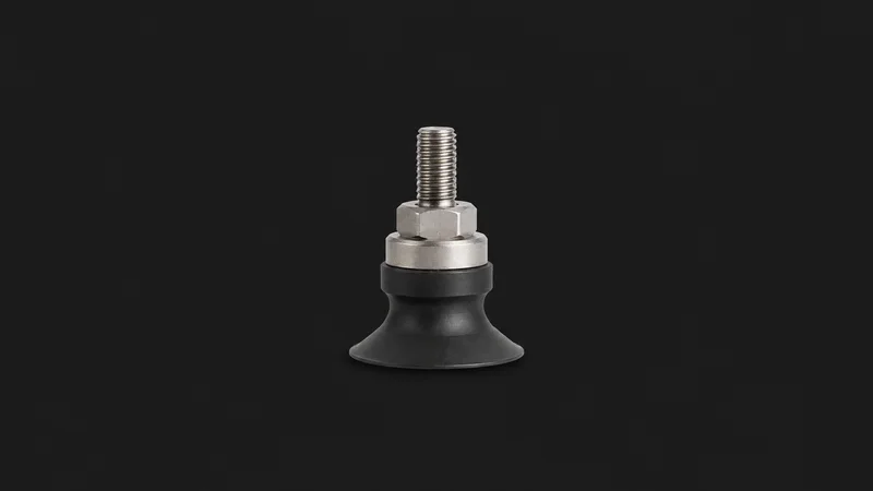 Isolated a rubber suction cup on a threaded pick-head stem centred on a seamless deep charcoal near-black studio background, generous empty margin on every side for overlaid branding