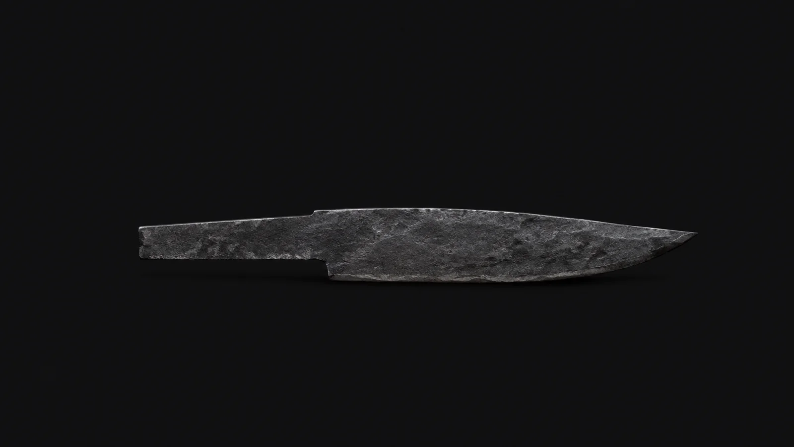 Isolated a rough-forged carbon-steel blade blank with hammer-scale still on it centred on a seamless deep charcoal near-black studio background, generous empty margin on every side for overlaid branding