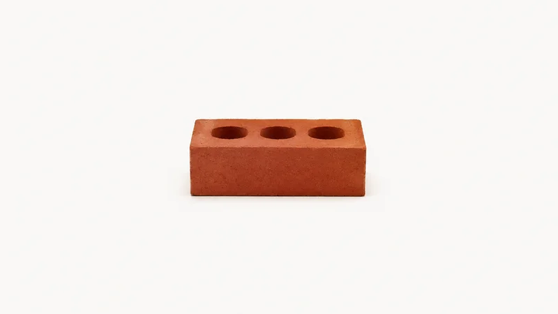 Isolated a single fired clay engineering brick with three frog holes centred on a seamless pale off-white studio background, generous empty margin on every side for overlaid branding