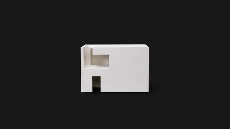 Isolated a white foam-board massing model of a simple block centred on a seamless deep charcoal near-black studio background, generous empty margin on every side for overlaid branding