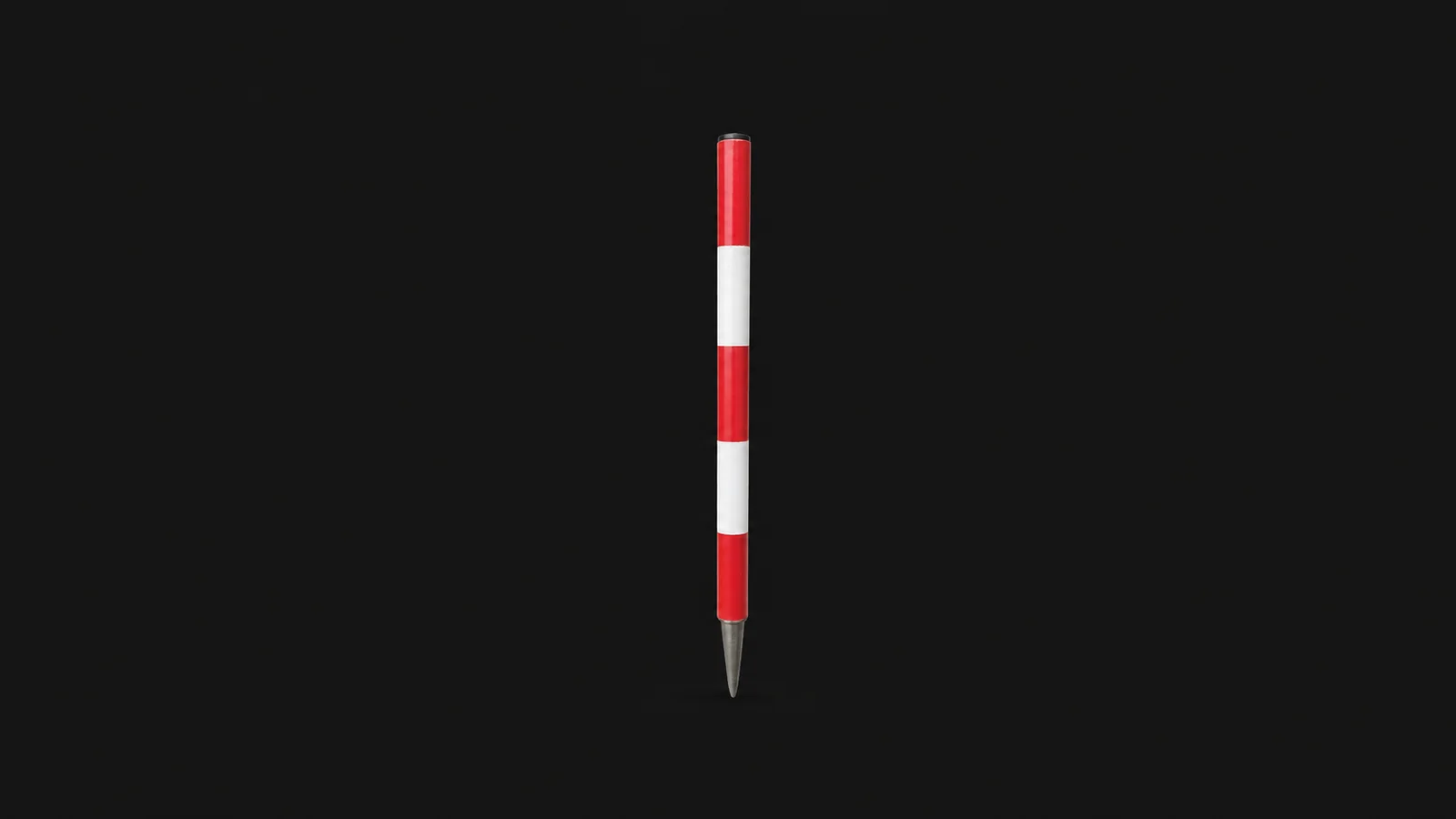 Isolated a red-and-white survey ranging pole with its steel point centred on a seamless deep charcoal near-black studio background, generous empty margin on every side for overlaid branding
