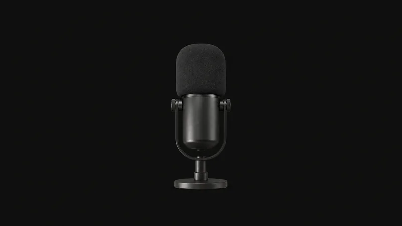 Isolated a dynamic broadcast microphone with a foam windscreen centred on a seamless deep charcoal near-black studio background, generous empty margin on every side for overlaid branding
