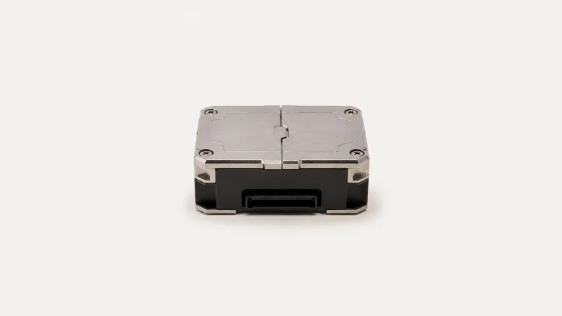 Isolated a hardware security module with a sealed tamper-evident lid centred on a seamless pale off-white studio background, generous empty margin on every side for overlaid branding