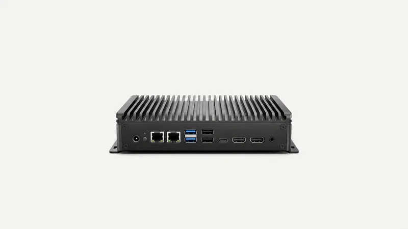 Isolated a fanless edge computer with finned heatsink housing centred on a seamless pale off-white studio background, generous empty margin on every side for overlaid branding