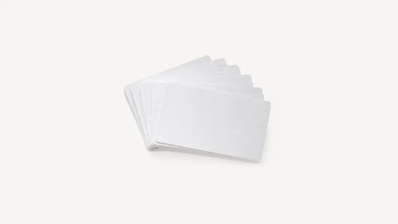 Isolated a set of blank process-mapping index cards in a fan centred on a seamless pale off-white studio background, generous empty margin on every side for overlaid branding