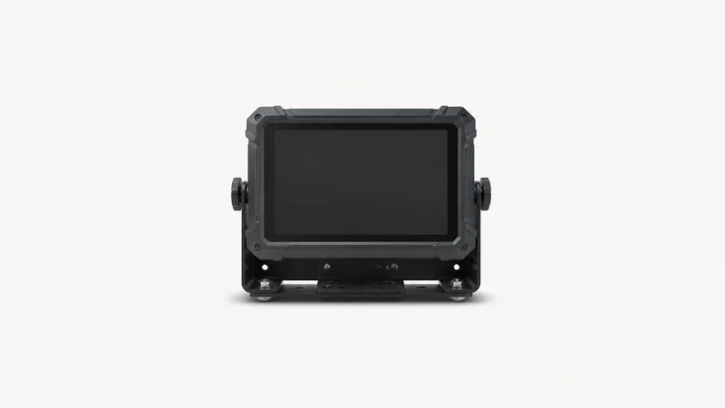 Isolated a rugged vehicle-mount terminal with a blank screen and heavy bracket centred on a seamless pale off-white studio background, generous empty margin on every side for overlaid branding