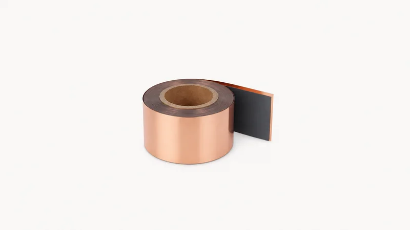 Isolated a coil of coated electrode on copper foil centred on a seamless pale off-white studio background, generous empty margin on every side for overlaid branding