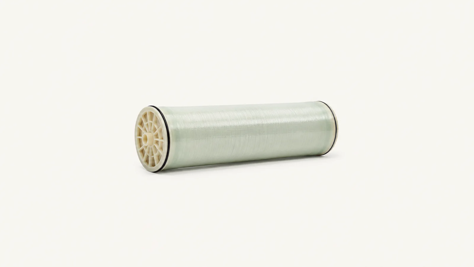 Isolated a spiral-wound reverse-osmosis membrane element centred on a seamless pale off-white studio background, generous empty margin on every side for overlaid branding