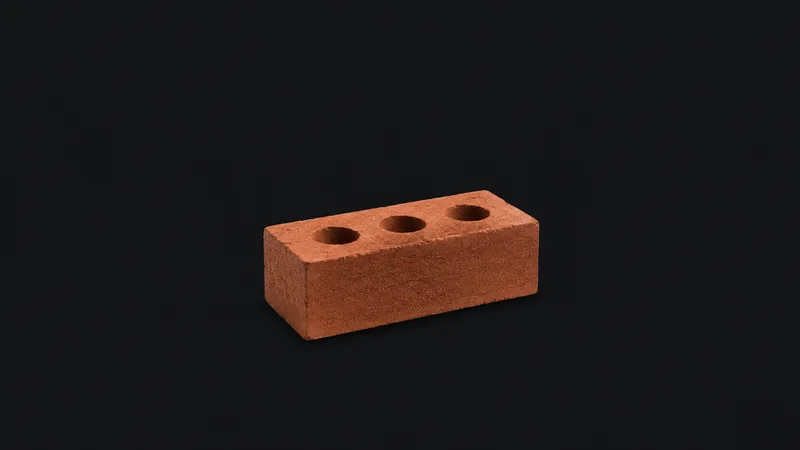 Isolated a single fired clay engineering brick with three frog holes centred on a seamless deep charcoal near-black studio background, generous empty margin on every side for overlaid branding