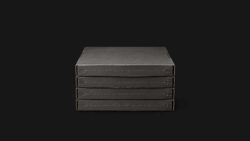 Isolated a stack of flat-pack mailer boxes with tear-strip perforations centred on a seamless deep charcoal near-black studio background, generous empty margin on every side for overlaid branding