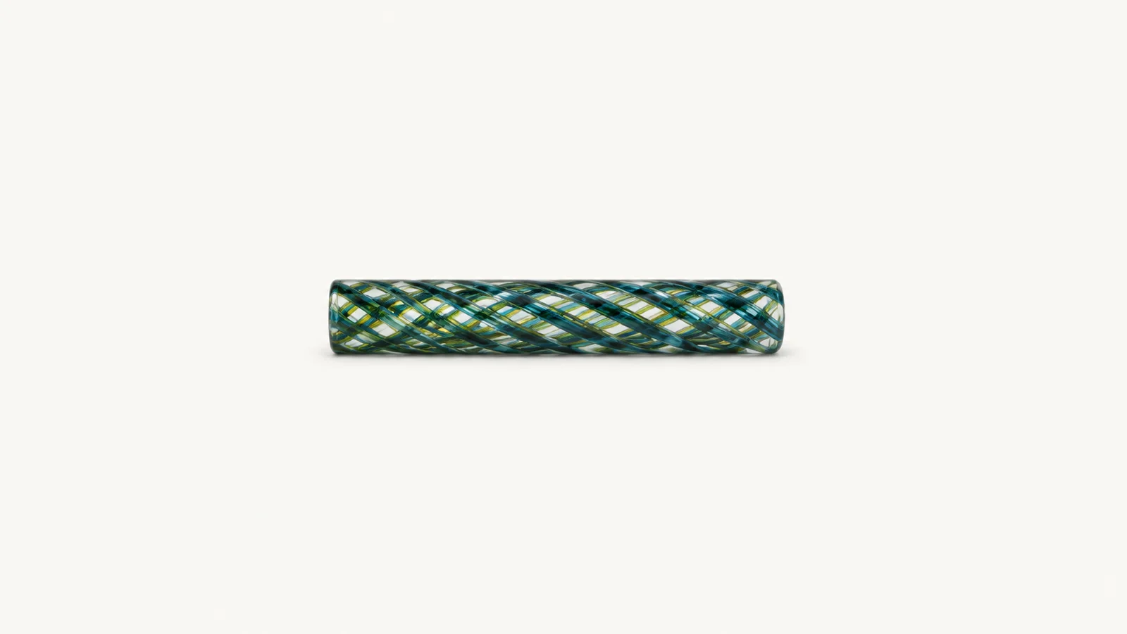 Isolated a rod of coloured glass cane with a twisted latticino core centred on a seamless pale off-white studio background, generous empty margin on every side for overlaid branding