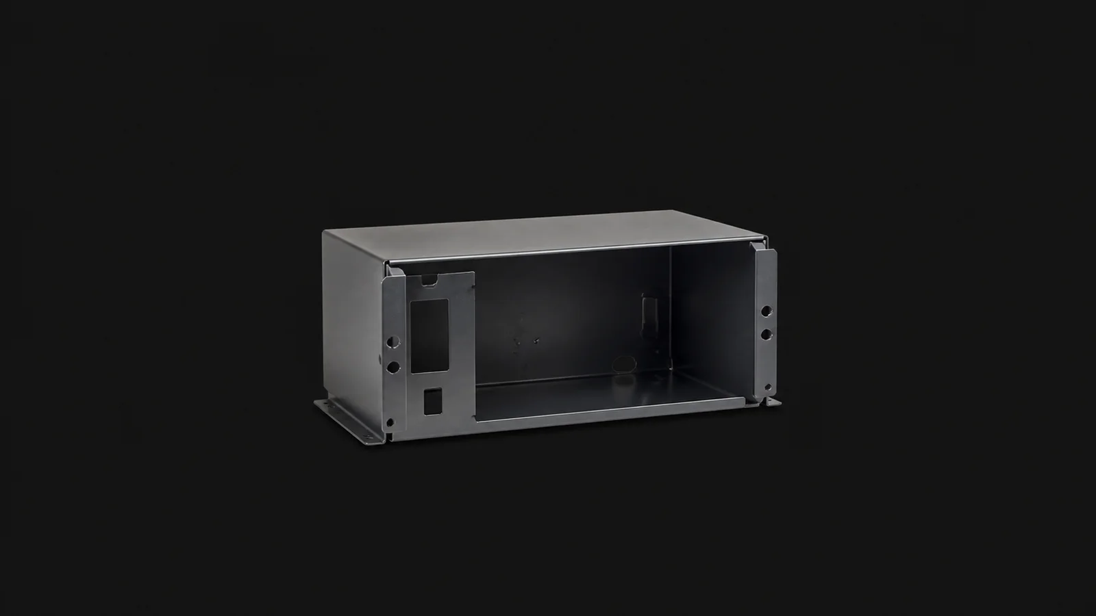 Isolated a press-braked sheet-steel enclosure with folded flanges centred on a seamless deep charcoal near-black studio background, generous empty margin on every side for overlaid branding