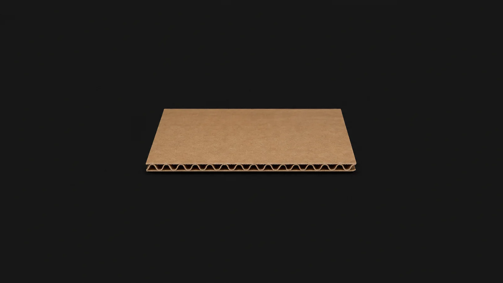 Isolated a single-wall corrugated board sample showing the fluted core centred on a seamless deep charcoal near-black studio background, generous empty margin on every side for overlaid branding
