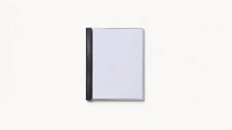 Isolated a bound presentation folder with a clear front cover centred on a seamless pale off-white studio background, generous empty margin on every side for overlaid branding