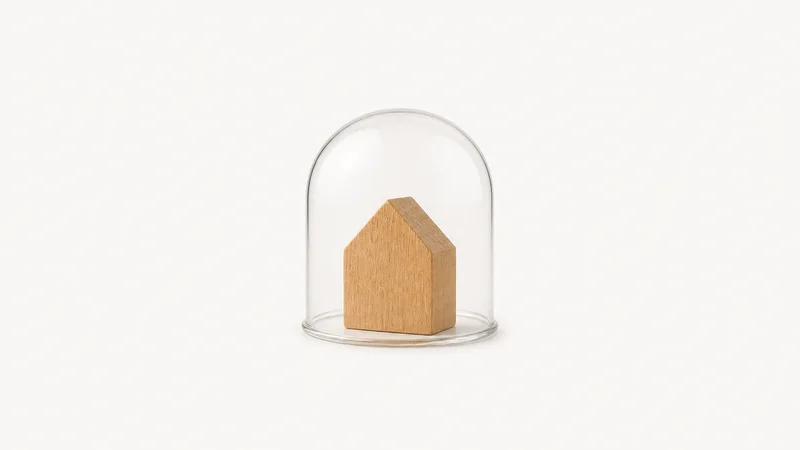 Isolated a house-shaped wooden block under a glass dome centred on a seamless pale off-white studio background, generous empty margin on every side for overlaid branding