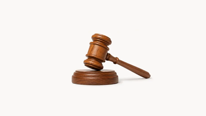 Isolated a wooden gavel and striking block on their own centred on a seamless pale off-white studio background, generous empty margin on every side for overlaid branding