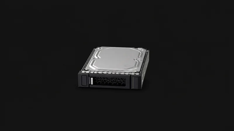 Isolated a hot-swap drive caddy holding an enterprise hard disk centred on a seamless deep charcoal near-black studio background, generous empty margin on every side for overlaid branding