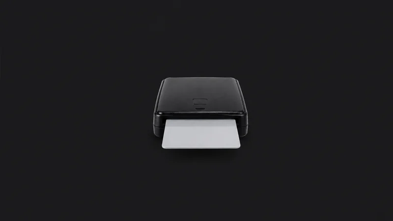 Isolated a smart card reader with a half-inserted blank card centred on a seamless deep charcoal near-black studio background, generous empty margin on every side for overlaid branding