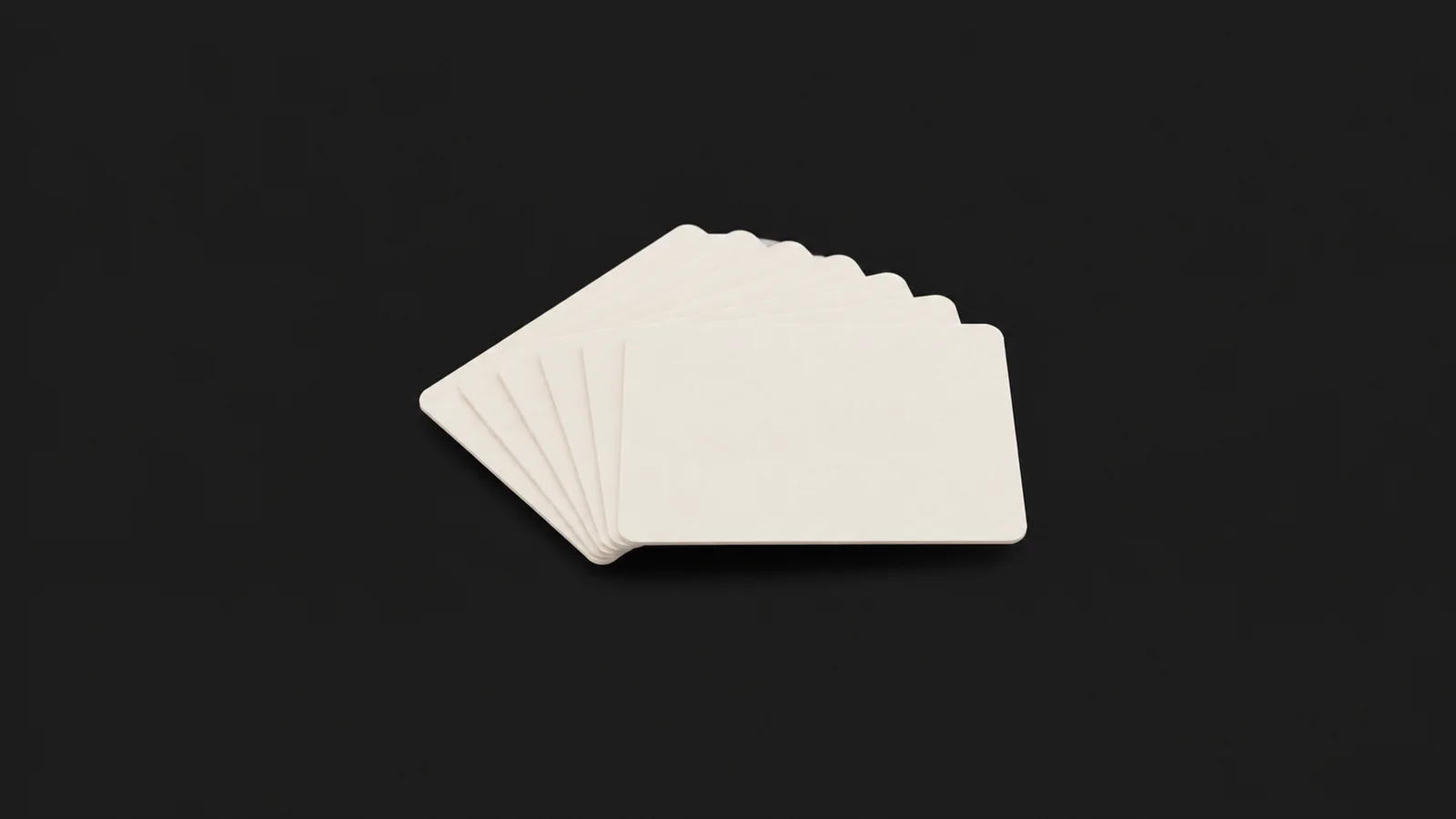 Isolated a set of blank process-mapping index cards in a fan centred on a seamless deep charcoal near-black studio background, generous empty margin on every side for overlaid branding