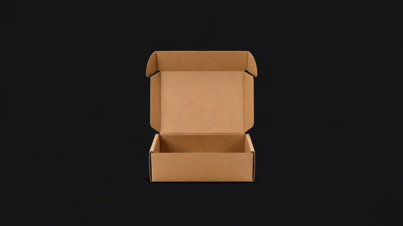 Isolated a plain kraft mailer box with the flap open centred on a seamless deep charcoal near-black studio background, generous empty margin on every side for overlaid branding